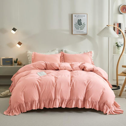 Pink bedding set on a bed in a bedroom with decor elements.