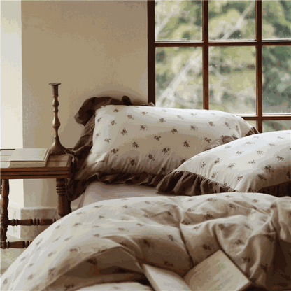 Ruffle Print Cotton Duvet Cover Set with vintage floral design and chocolate ruffle trim on a bed in a cozy room.