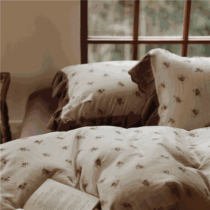 Ruffle Print Cotton Duvet Cover Set with vintage floral design and chocolate ruffle trim on bed.