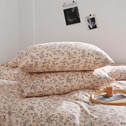 pink beige duvet cover set with vintage floral design on bed with pillows